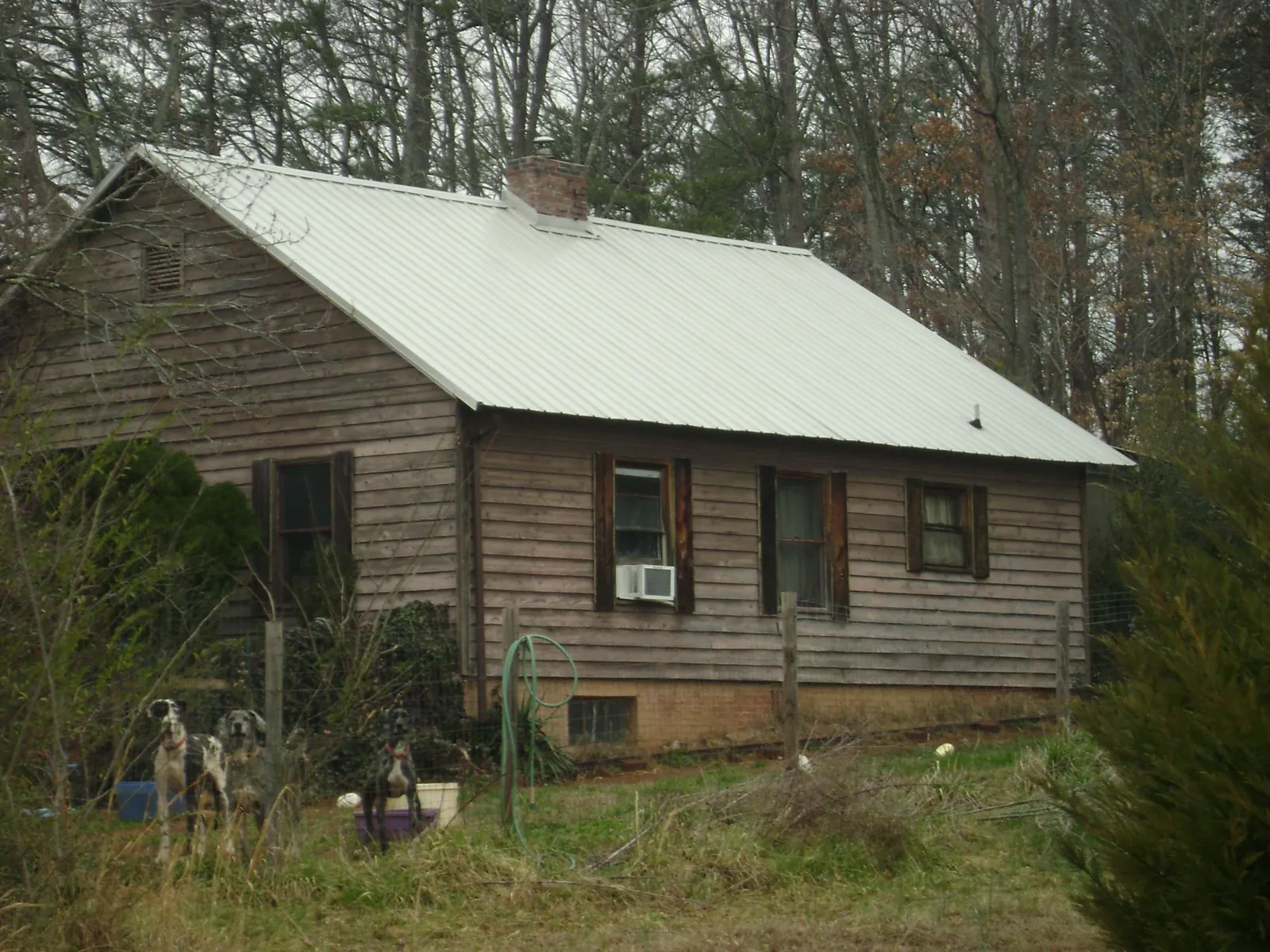White metal roof on an old wood sided farmhouse, from a Metal Roof Installation job in Avon